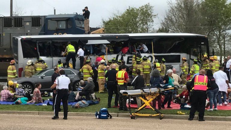 Bomberos, rescatistas y param&eacute;dicos auxilian a los sobrevivientes del accidente entre un tren y un autob&uacute;s en una ciudad de Mississippi, EEUU