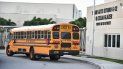 Un autobús escolar aguarda frente a una escuela. Un autobús escolar aguarda frente a una escuela.