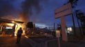 Una persona en la Mesa, California, observa mientras se incendia un banco el domingo 31 de mayo de 2020 durante los disturbios por la muerte hace unos días de George Floyd en Minneapolis. Una persona en la Mesa, California, observa mientras se incendia un banco el domingo 31 de mayo de 2020 durante los disturbios por la muerte hace unos días de George Floyd en Minneapolis.