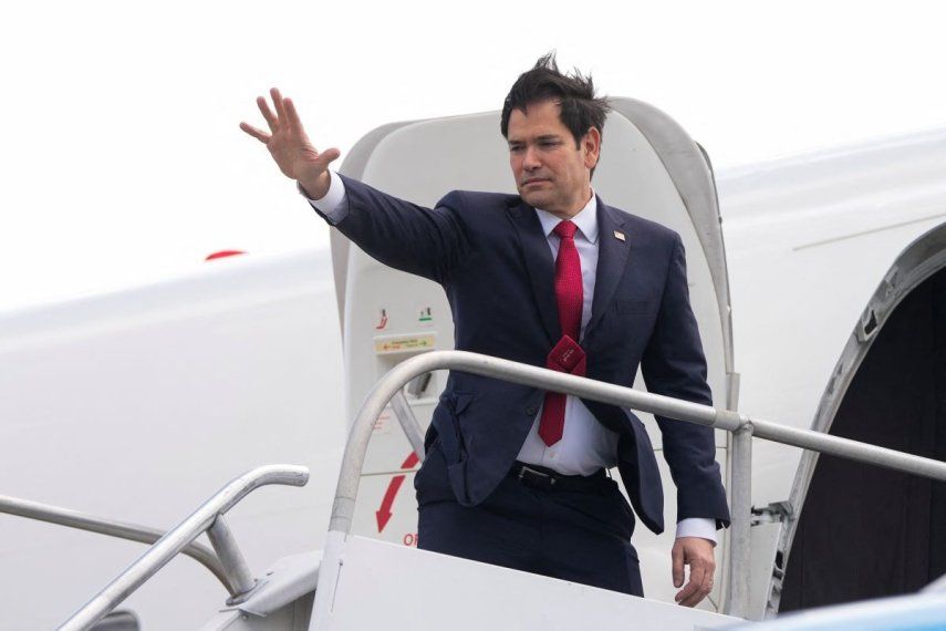 El secretario de Estado de Estados Unidos, Marco Rubio, saluda mientras aborda un avión para iniciar su gira diplomática.