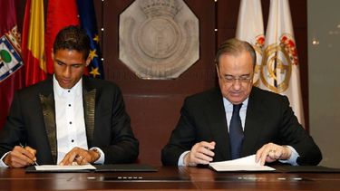 Varane (izquierda) durante la firma del acuerdo con el presidente del Real Madrid, Florentino Pérez. 