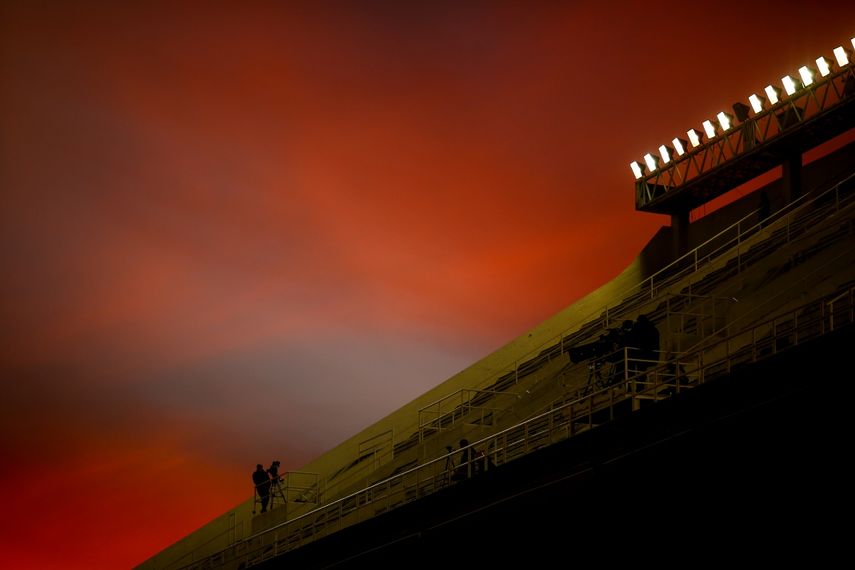 Un reportero aguarda en las gradas vacías de un estadio de Buenos Aires previo al partido entre Vélez Sarsfield y Liga de Quito, el 13 de mayo de 2021