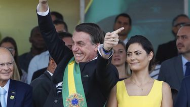 El mandatario Jair Bolsonaro saluda al público acompañado por la primera dama Michelle Bolsonaro, durante el desfile militar en los festejos por el día de la Independencia, en Brasilia, Brasil, el sábado 7 de septiembre de 2019. 