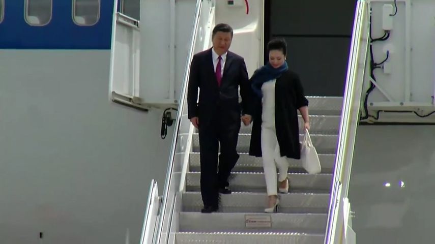 El presidente chino Xi Jinping y su esposa descienden del avión presidencial que los trajo a Palm Beach, Florida.