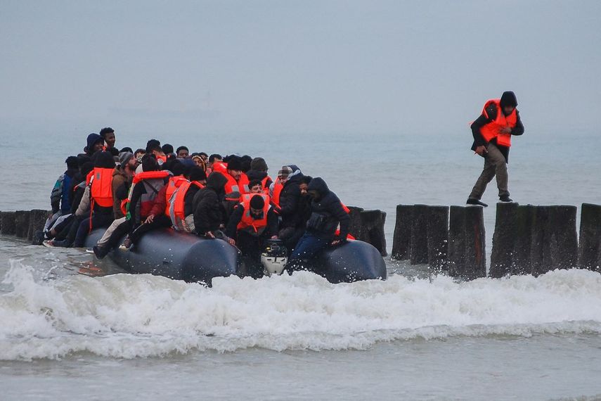 Un migrante regresa a la orilla de la costa después de intentar cruzar el Canal de la Mancha para llegar a Gran Bretaña en un bote inflable propiedad de contrabandistas en la playa de Sangatte, cerca de Calais, en el norte de Francia.