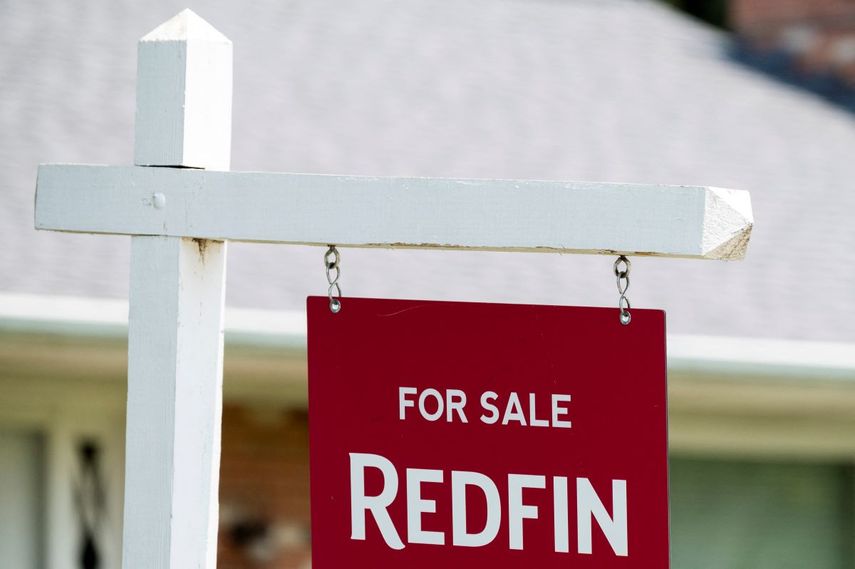 Letrero de la firma inmobiliaria Redfin afuera de una vivienda en venta.
