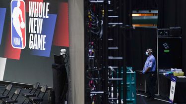 &nbsp;En esta foto del 29 de julio de 2020, un guardia de seguridad con mascarilla trabaja cerca de una arena dentro de la burbuja de ESPN en Lake Buena Vista, Florida