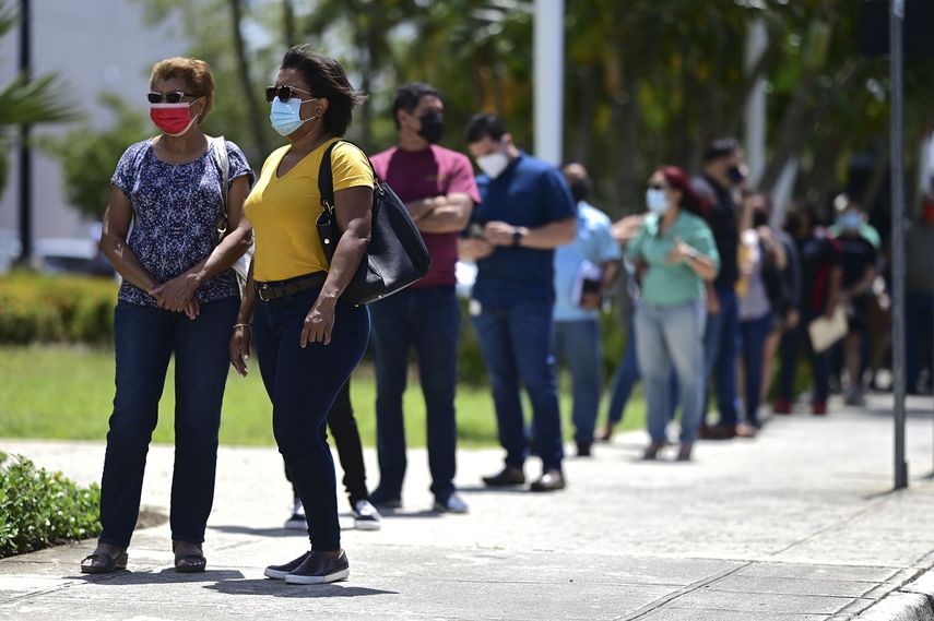 Numerosas personas hacen fila afuera del Centro de Convenciones Miramar para recibir su vacuna en una campaña a cargo del Departamento de Salud y la organización sin fines de lucro Voces, que pretenden aplicar 10.000 vacunas de Johnson & Johnson, en San Juan, Puerto Rico, el miércoles 31 de marzo de 2021.&nbsp;