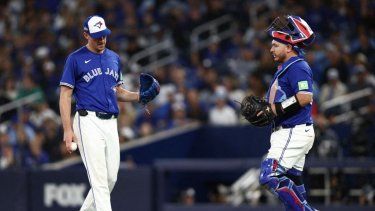 Chris Bassitt #40 and Alejandro Kirk #30 of the Toronto Blue Jays speak on the field during the eighth inning against the Seattle Mariners in game two of the American League Championship Series at Rogers Centre on October 13, 2025 in Toronto, Ontario.&nbsp;