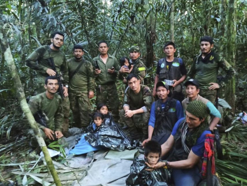 En esta foto difundida por la Oficina de Prensa de las Fuerzas Armadas de Colombia, soldados e indígenas posan con los cuatro hermanos que llevaban 40 días desaparecidos en la selva de Solano, estado de Caquetá, Colombia, el viernes 9 de junio de 2023.
