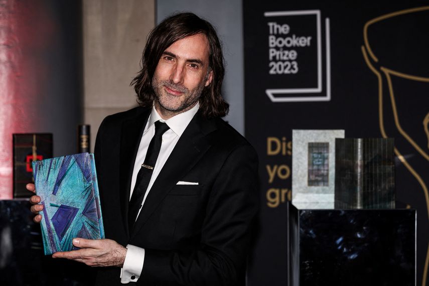 El escritor irlandés Paul Lynch posa con la copia de su libro Prophet Song en la alfombra roja del Premio Booker, en Old Billingsgate, en el centro de Londres, el 26 de noviembre de 2023.