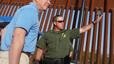 El secretario de Seguridad Nacional, Alejandro Mayorkas, escucha a Anthony Crane, agente de la Patrulla Fronteriza, durante un recorrido de un tramo del muro fronterizo, el martes 17 de mayo de 2022, en Hidalgo, Texas.&nbsp;