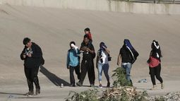 Un grupo de migrantes venezolanos caminan hacia la frontera de Estados Unidos para entregarse a la patrulla fronteriza, en Ciudad Juárez, México, el 13 de octubre de 2022.&nbsp;
