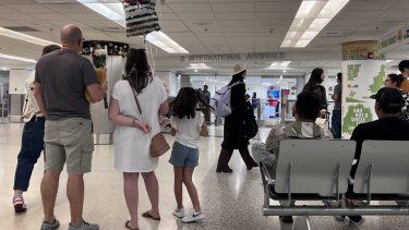 Varias personas esperan a sus seres queridos en una puerta de llegadas internacionales del Aeropuerto de Miami.&nbsp;