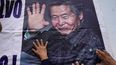 Los partidarios del expresidente encarcelado Alberto Fujimori tocan un cartel con su foto, afuera de la prisión donde está internado en las afueras de Lima, Perú, el martes 5 de diciembre de 2023.