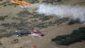 Dos helicópteros combaten un incendio en Springville, Utah, el lunes 1 de agosto de 2022. 