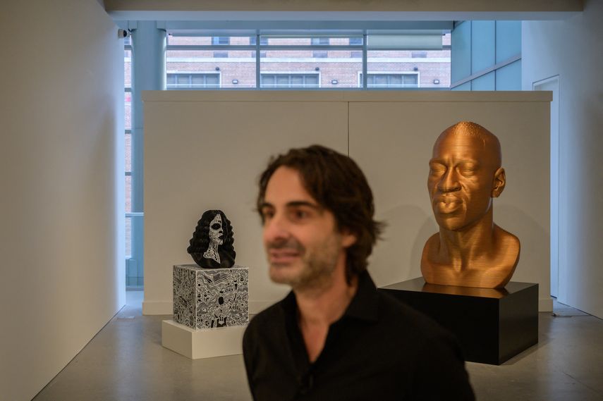 El artista Chris Carnabuci posa ante sus esculturas de George Floyd y Breonna Taylor en la casa de subastas Sothebys en Nueva York el 9 de diciembre de 2021.