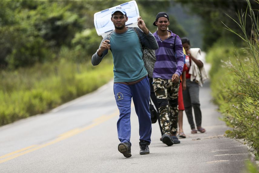 Grupo de venezolanos caminan por una carretera en el estado Roraima en la Amazonía brasileña el 22AGO18,