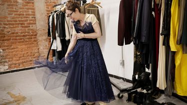 La diseñadora de moda mexicana Gabriela Fernández toma un vestido en su estudio en la Ciudad de México el 31 de agosto de 2024.