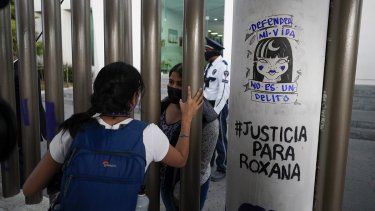 Roxana Ruiz, detrás de la puerta, habla desde el interior de un complejo de tribunales previo a su audiencia en Chimalhuacán, Estado de México, el 18 de abril de 2022.&nbsp;