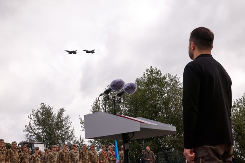En esta fotografía tomada y difundida por el Servicio de Prensa Presidencial de Ucrania el 4 de agosto de 2024, el presidente de Ucrania, Volodymyr Zelensky, observa un par de aviones F16 que vuelan durante las celebraciones del Día de la Fuerza Aérea de Ucrania en un lugar no revelado, en medio de la invasión rusa de Ucrania