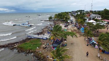 Migrantes se reúnen en Necoclí, Colombia, un punto de parada para los migrantes que toman embarcaciones hacia Acandí, una localidad que conduce a la selva del Tapón del Darién.