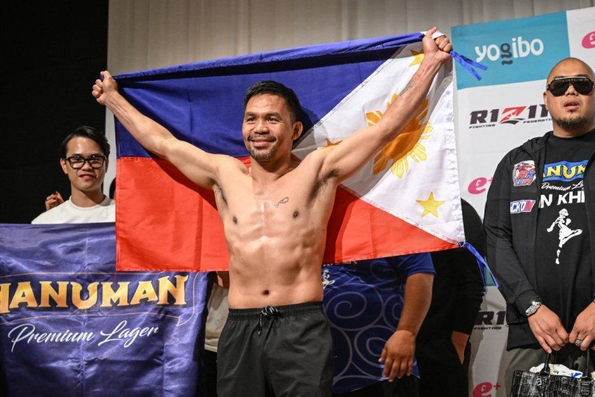 La leyenda del boxeo Manny Pacquiao posa con la bandera de Filipinas en Tokio, el 27 de julio de 2024.