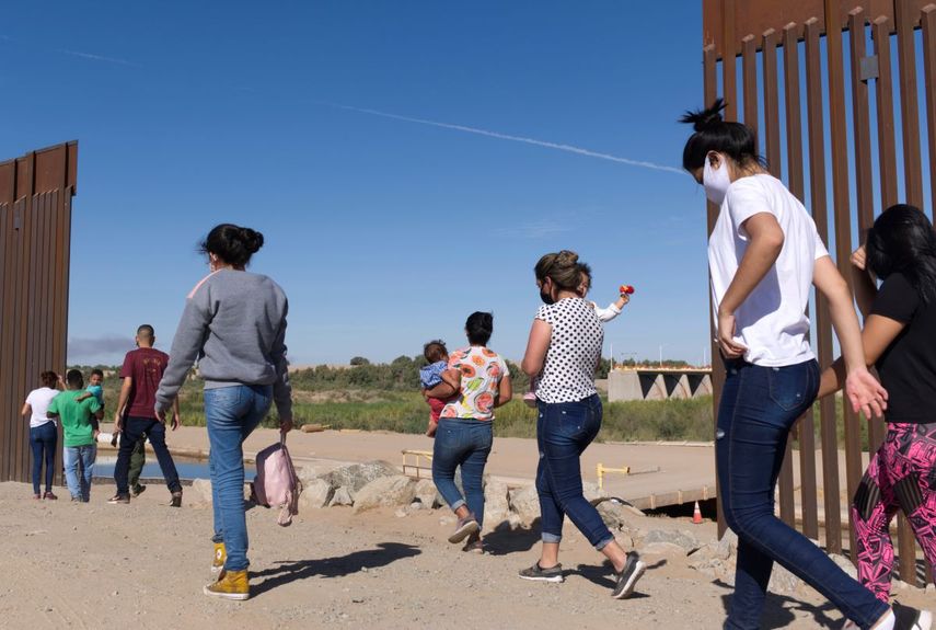 Un grupo de migrantes brasileños ingresan a Estados Unidos desde México el 8 de junio de 2021 a través de una brecha en el muro fronterizo, en Yuma, Arizona, con el fin de solicitar asilo a las autoridades migratorias estadounidenses