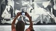 Una mujer fotografía la obra de Picasso Guernica durante la presentación de los actos conmemorativos del Año Picasso, en el Museo Reina Sofía, el 12 de septiembre de 2022, en Madrid (España).
