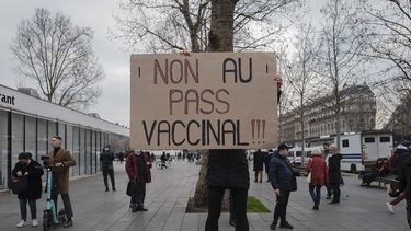 Una persona sostiene un cartel con el mensaje ¡No al pase de vacunas! en una protesta contra el pase de vacunas contra el COVID-19, en París, Francia, el sábado 22 de enero de 2022.&nbsp;