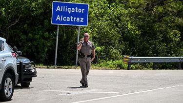 Un oficial de la Patrulla de Carreteras de Florida observa mientras un grupo de manifestantes se reúnen para exigir el cierre del centro de detención de inmigrantes conocido como Alligator Alcatraz en el condado Dade-Collier en Florida.