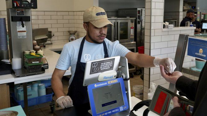 Un empleado cobra en un establecimiento Auntie Annes and Cinnabon en Livermore, California, el jueves 28 de marzo de 2024. Es uno de los cientos de miles de trabajadores de comida rápida en California que ganarán al menos 20 dólares la hora a partir del lunes 1 de abril.&nbsp;