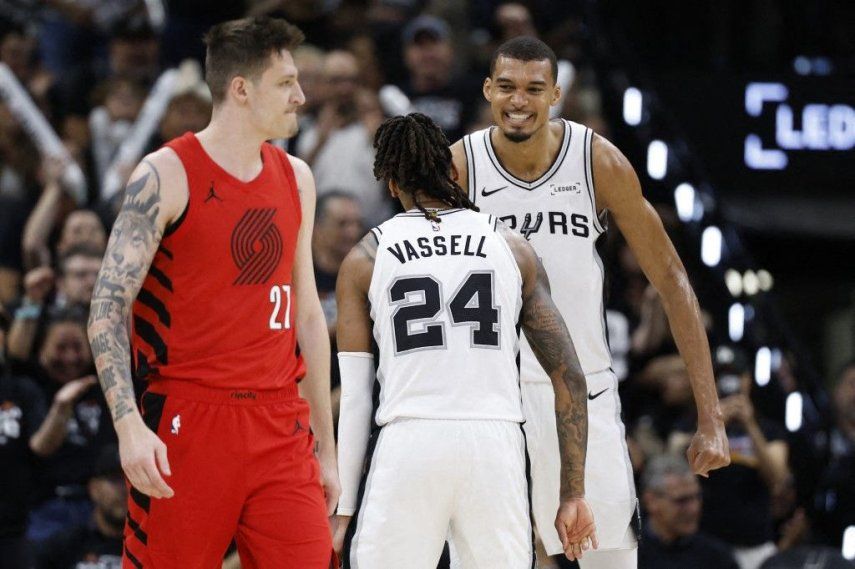Victor Wembanyama #1 y Devin Vassell #24 de los San Antonio Spurs reaccionan detrás de Vit Krejci #27 de los Portland Trail Blazers durante la segunda mitad del quinto partido de la primera ronda de los playoffs de la Conferencia Oeste de la NBA en el Frost Bank Center el 28 de abril de 2026 en San Antonio, Texas.&nbsp;