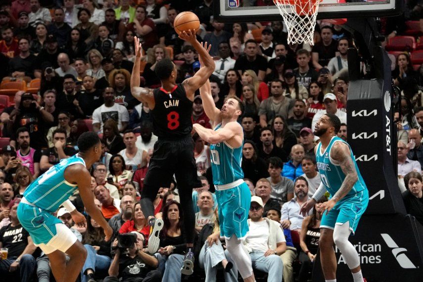 Jamal Cain (8), del Heat de Miami, dispara sobre Gordon Hayward (20), de los Hornets de Charlotte, durante la segunda mitad del juego de baloncesto de la NBA, el miércoles 13 de diciembre de 2023, en Miami.&nbsp;