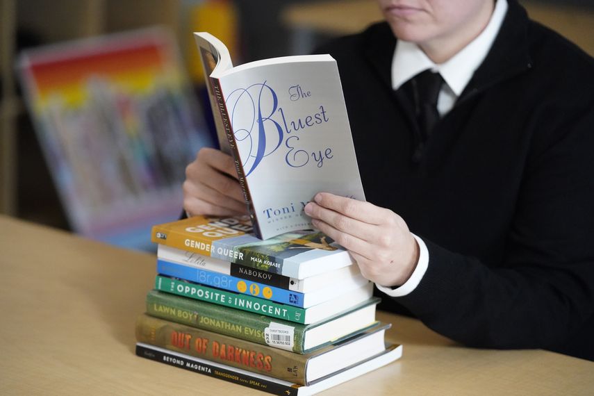 Amanda Darrow, directora los programas de educación para jóvenes y familias en el Centro de Orgullo de Utah, posa con unos libros que han sido objeto de críticas por parte de los padres, el 16 de diciembre de 2021, en Salt Lake City. La inteligencia artificial sacude el mundo de la edición.