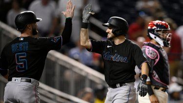 Garrett Hampson, de los Marlins de Miami, festeja con su compañero Jon Berti, luego de conectar un jonrón de dos carreras ante los Nacionales de Washington, el viernes 1 de septiembre de 2023.