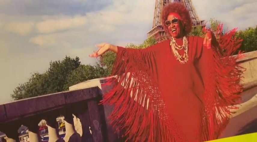 Fotografía de Celia Cruz en París, capturando un momento icónico de su carrera internacional.