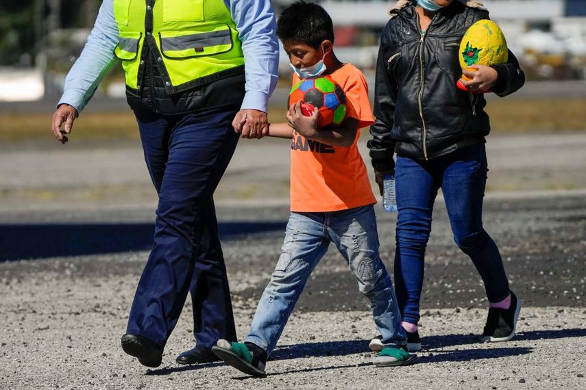 Dos jóvenes guatemaltecos no acompañados que fueron deportados desde México desembarcan de un avión en el aeropuerto internacional de La Aurora, junto a otros niños deportados, en Ciudad de Guatemala, el martes 7 de febrero de 2023