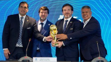 El presidente de la federación de Paraguay Robert Harrison (izquierda), el presidente de la federación de Uruguay Ignacio Alonso (centro), el presidente de la CONMEBOL Alejandro Domínguez (tercero a la izquierda y el presidente de la federación de Argentina Claudio Tapia sostiene el trofeo de la Copa Mundial de la FIFA durante una rueda de prensa, el miércoles 4 de octubre de 2023, en Luque, Paraguay. Domínguez anunció que los partidos inaugurales del Mundial 2030 se jugarán en Argentina, Uruguay y Paraguay.&nbsp;
