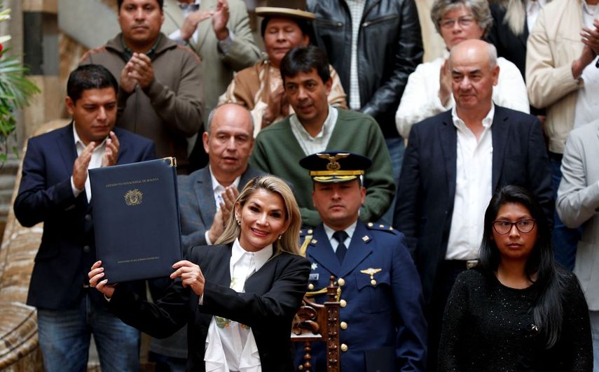La presidenta interina de Bolivia, Jeanine Áñez, a la izquierda, posa para una foto después de promulgar una ley para celebrar nuevas elecciones, en La Paz, Bolivia, el domingo 24 de noviembre de 2019. 