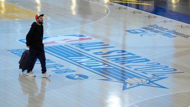 Los viajeros que utilizan el Aeropuerto Internacional de Indianápolis cruzan una réplica de la cancha que se usará para el Juego de Estrellas de la NBA el jueves 18 de enero de 2024. Las autoridades han creado una réplica de la cancha de baloncesto de tamaño real con dos canastas, una equipada con un reloj corto, para promover el primer Juego de Estrellas de Indy desde 1984.&nbsp;