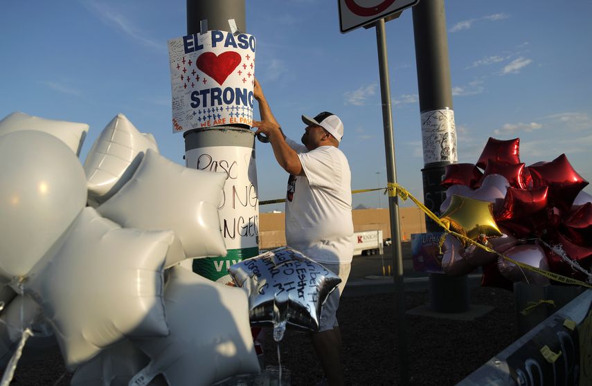Foto&nbsp;de archivo del 6 de agosto de 2019 de un hombre que coloca un cartel de El Paso Strong (Fuerza El Paso) en un monumento improvisado a las v&iacute;ctimas de la masacre de El Paso, Texas.&nbsp;