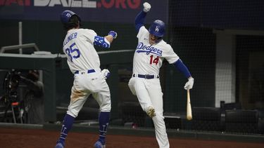 El jugador de los Dodgers de Los Ángeles Cody Bellinger celebra su jonrón con Kiké Hernández, en el séptimo juego contra los Bravos de Atlanta por el campeonato de la Liga Nacional, el domingo 18 de octubre de 2020 en Arlington, Texas.