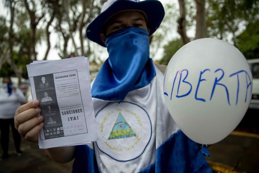 Un hombre con la cara cubierta participa en una protesta frente a la iglesia San Agustín en Managua (Nicaragua), para exigir al presidente Daniel Ortega la liberación de todos los presos políticos.
