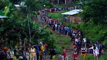 Migrantes que buscan llegar a Estados Unidos hacen fila para tomar un bote en Bajo Chiquito, en la provincia de Darién en Panamá. La mayoría de los venezolanos cruzaron la peligrosa Selva para llegar a EEUU. 520.000 personas cruzaron el Darién en 2023