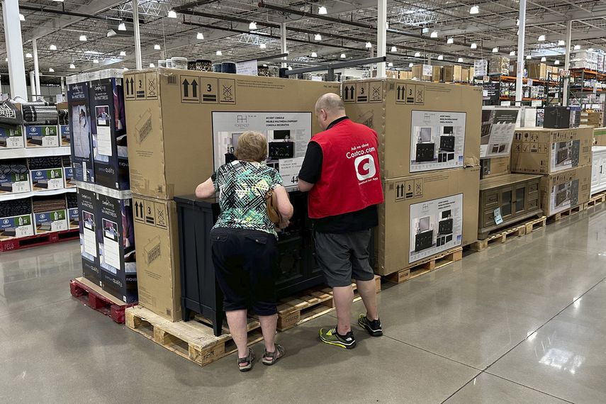 Un empleado de la cadena minoristas Costco dialoga con un cliente.