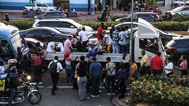 Personas viajan en un camión durante un apagón nacional en Santo Domingo el 11 de noviembre de 2025. Santa Domingo se quedó sin electricidad el martes cuando la compañía eléctrica de la República Dominicana anunció un apagón de alcance no especificado, causado por una falla en el sistema de transmisión.