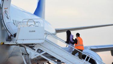 Migrantes venezolanos abordan un avión con destino a su país natal en Harlingen, Texas, el miércoles 18 de octubre de 2023.