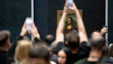 Visitantes toman fotografías del cuadro Mona Lisa (La Gioconda) de Leonardo Da Vinci, en el Museo del Louvre, en París, el 17 de abril de 2024.