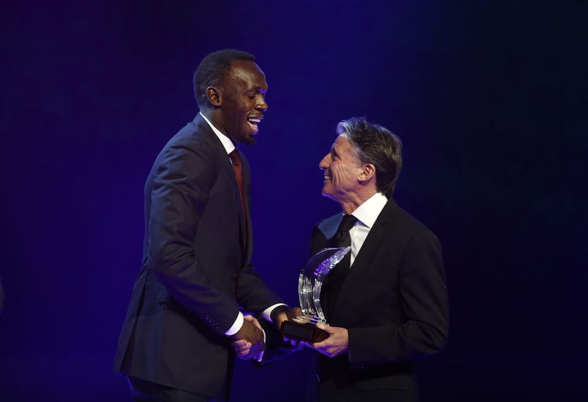 Bolt (izquierda) recibió del presidente del la IAAF, Sebastian Coe (derecha), el premio como Atleta del Año